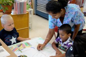 teacher helping with coloring